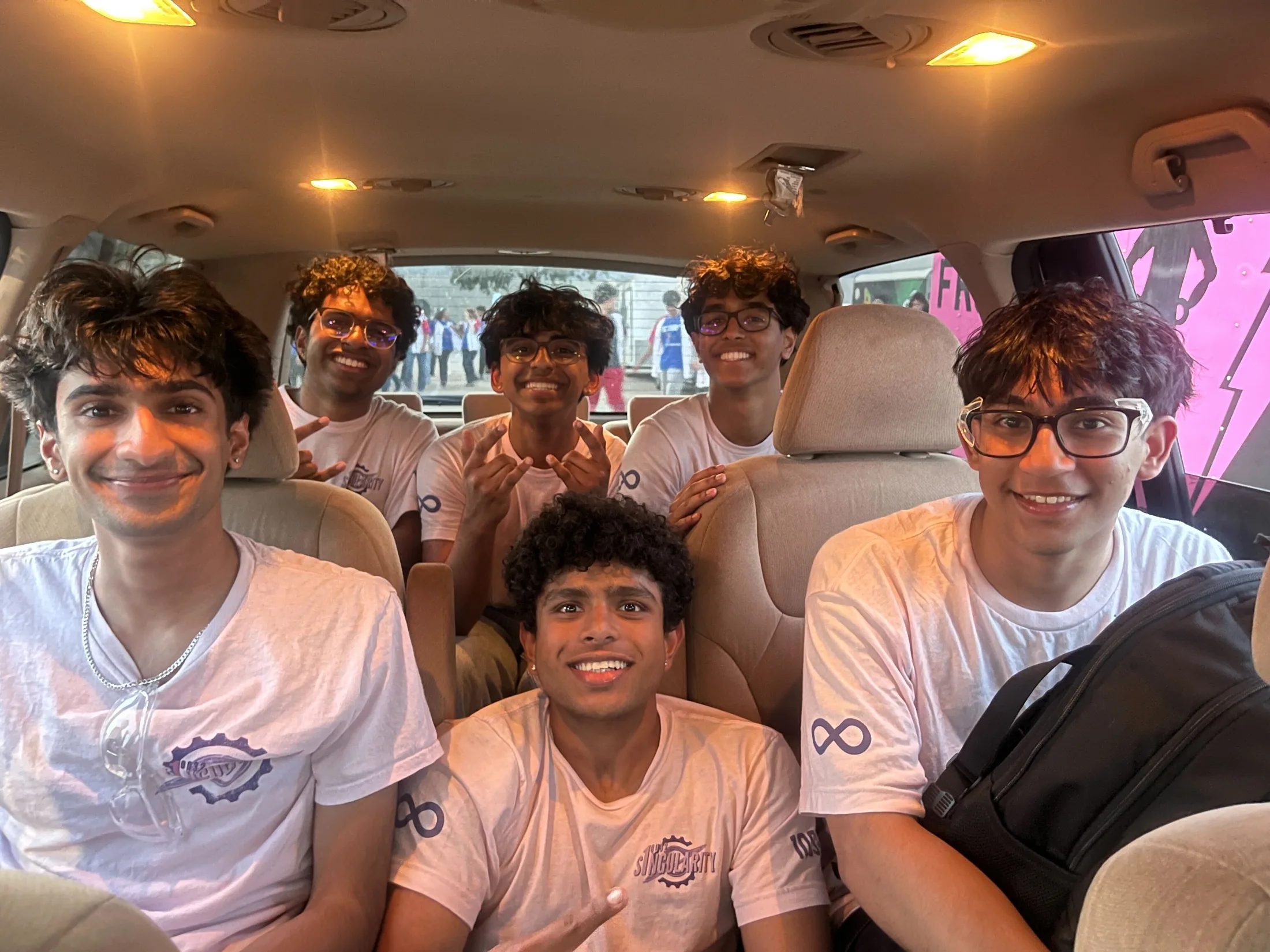 Students in a car, candid, smiling
